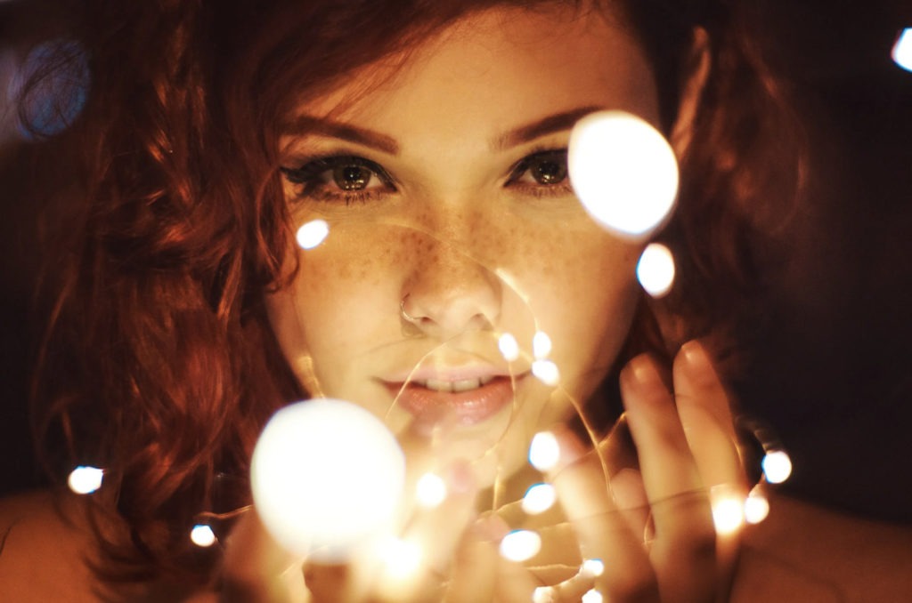 girl holding fairy lights