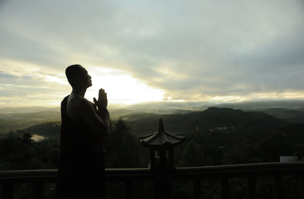 monk looking at sunrise