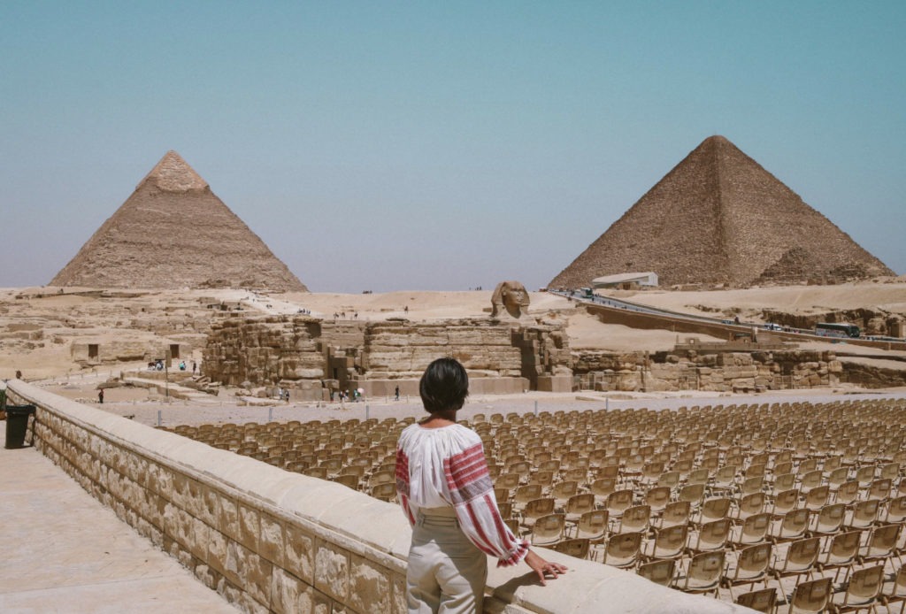 girl looking at the pyramids in Egypt
