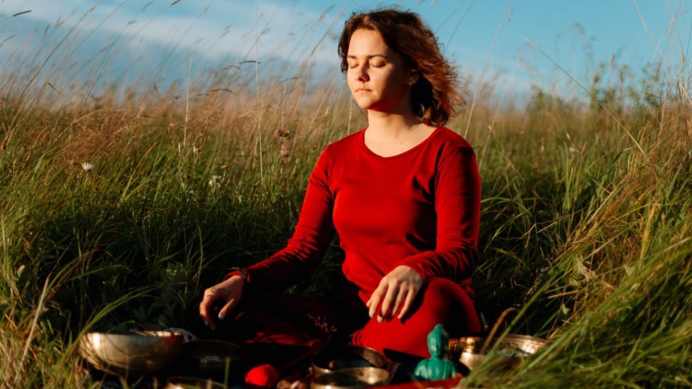 Woman meditating in the grass