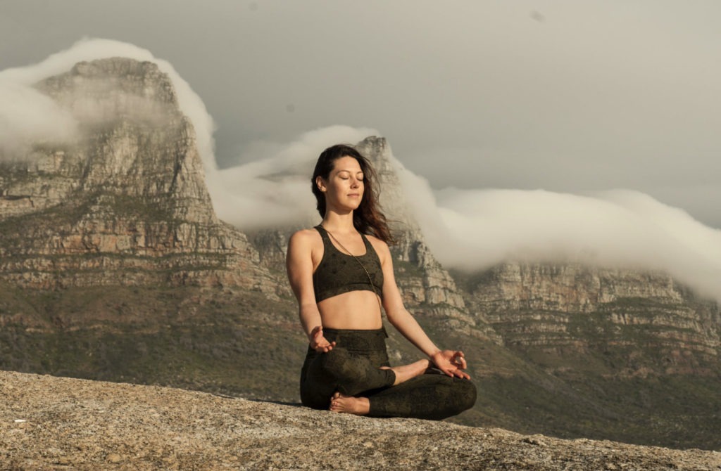 girl meditating on mountain