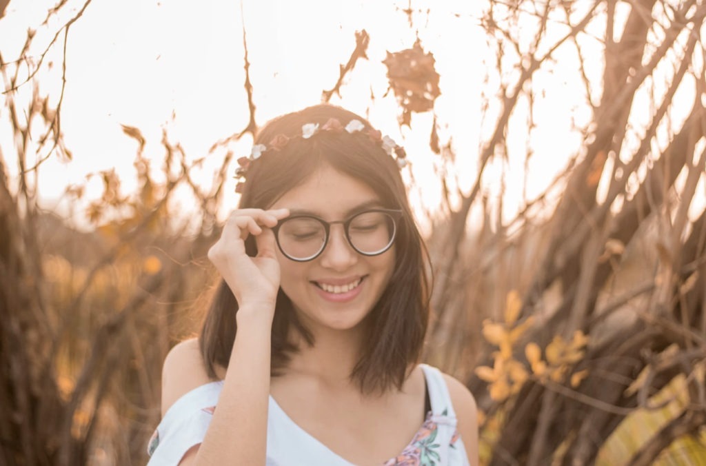girl with glasses in a field