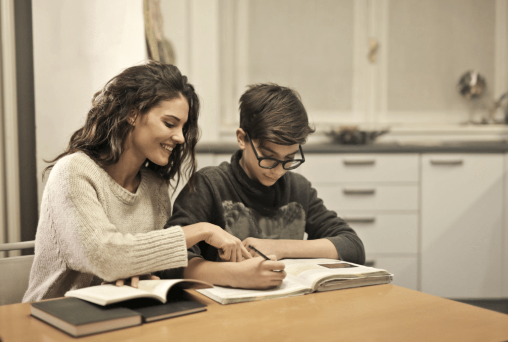 woman teaching a boy math