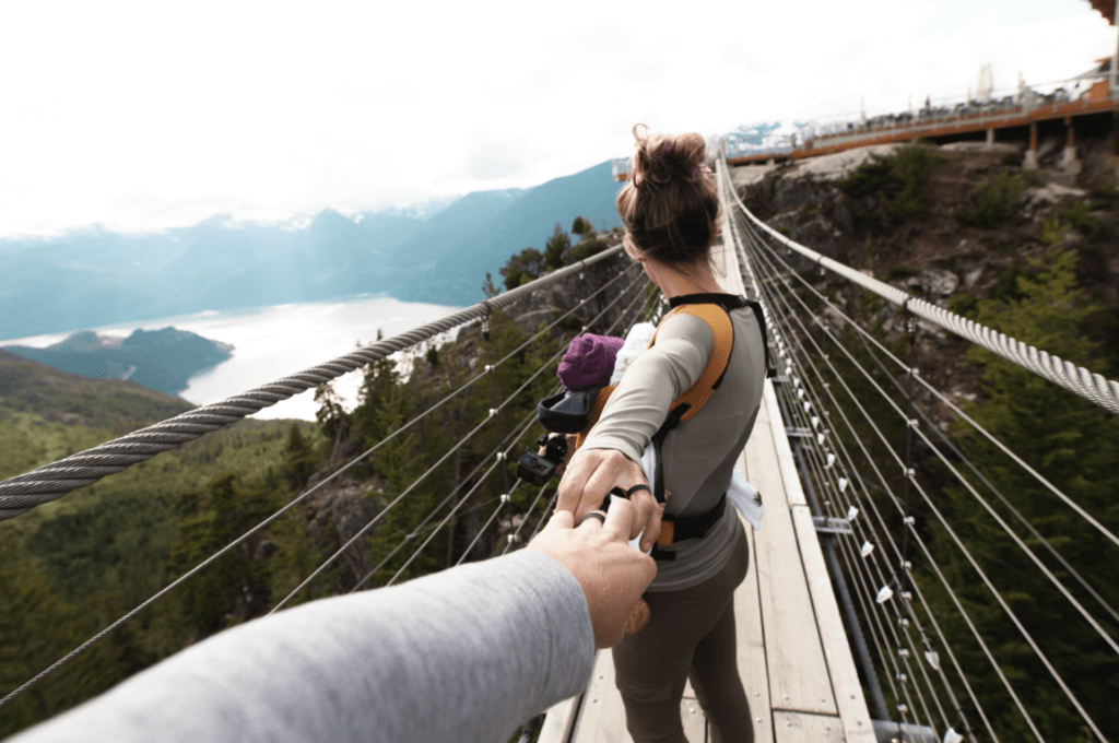 girl hiking holding hand with husband