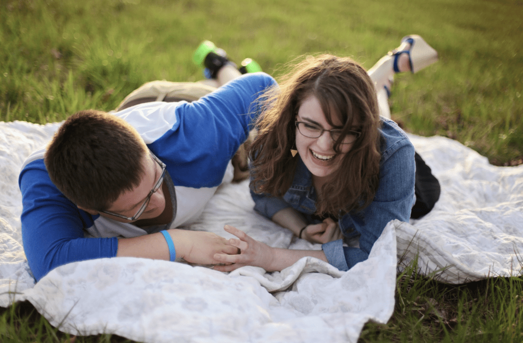 couple laughing on the grass