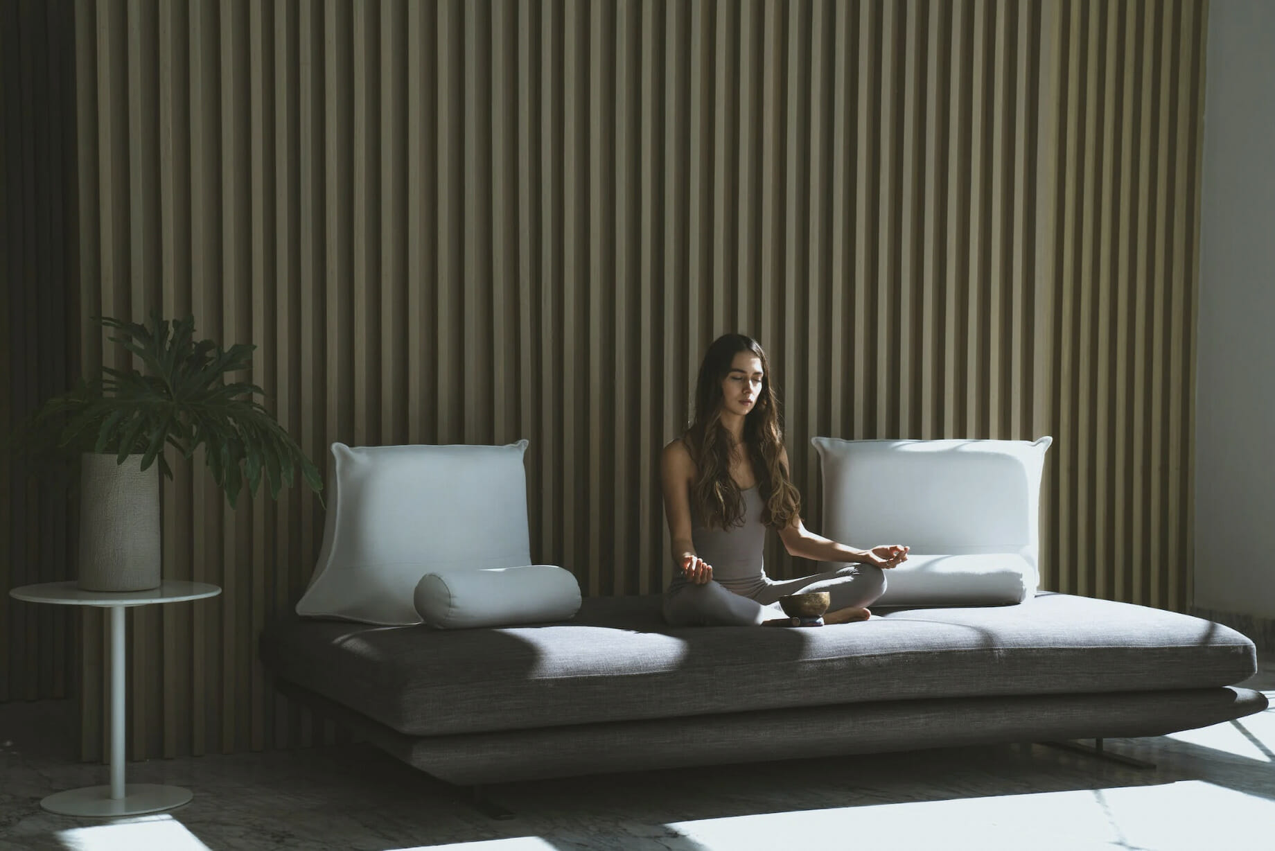 a woman meditating on her couch