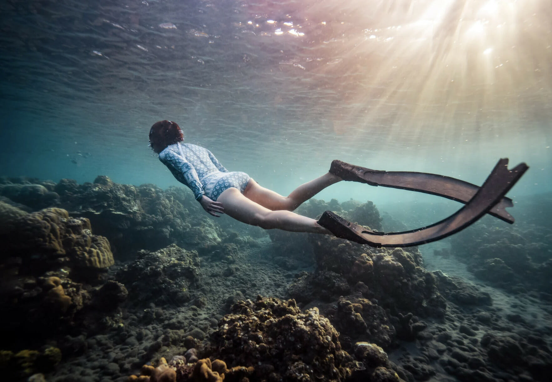 person freediving underwater