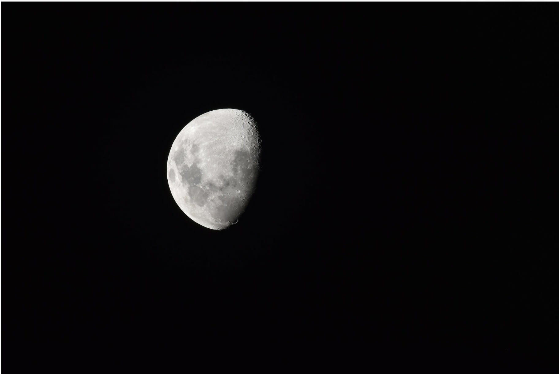 waning gibbous moon in the dark night sky
