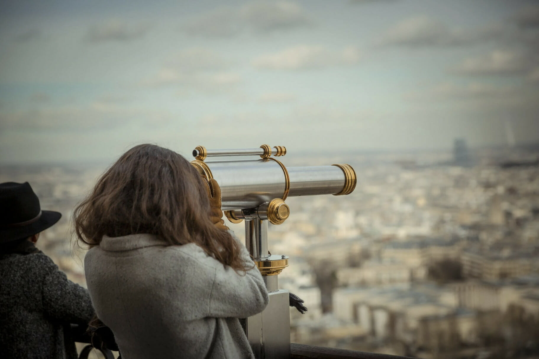 girl looking at telescope